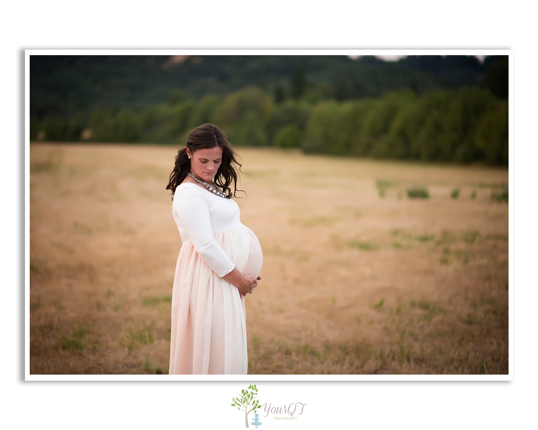 Carrie Maternity Portland Oregon Pink Blush Dress Looking Down in a field