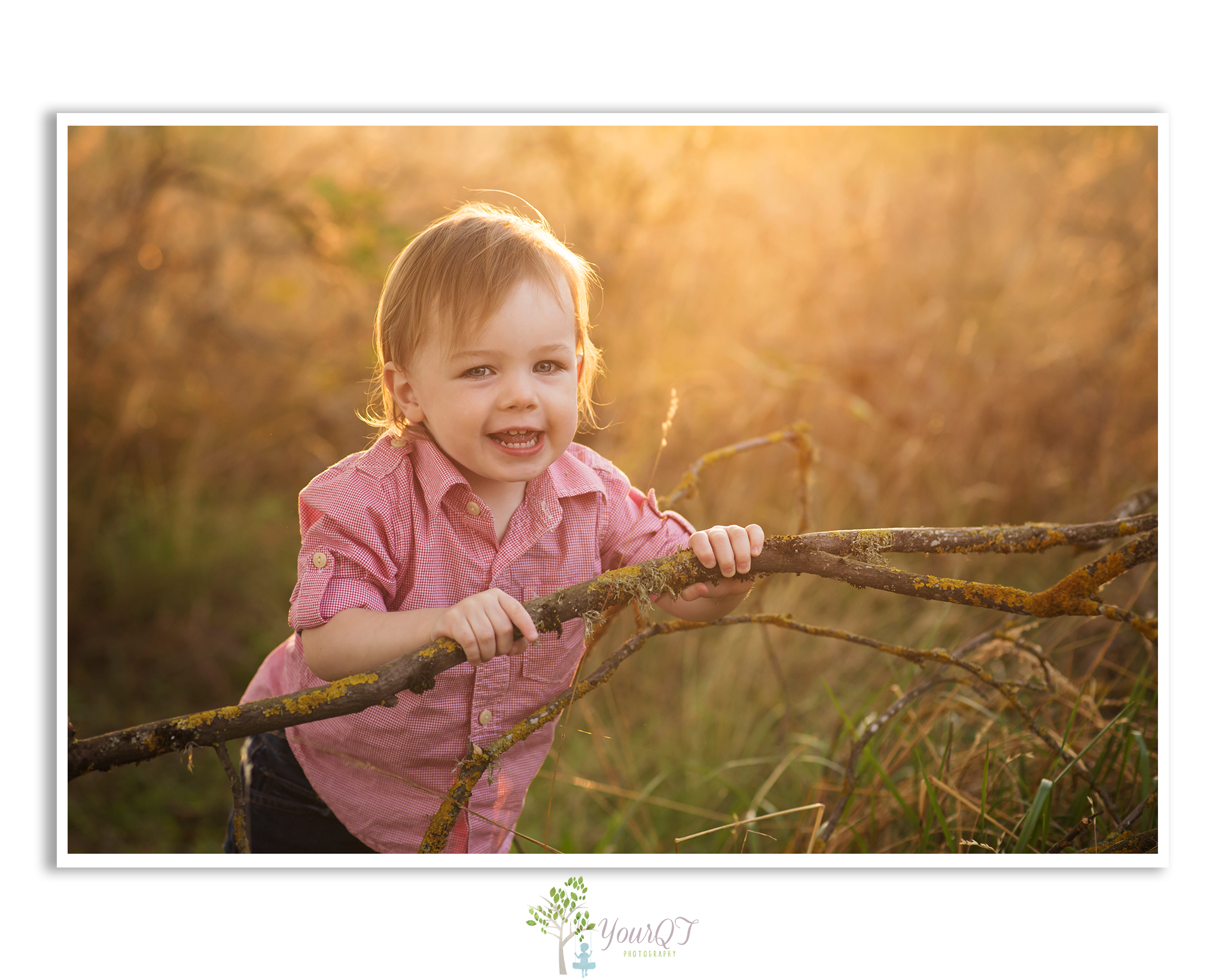 Schultz Family Preview Boy in a field playing with a stick
